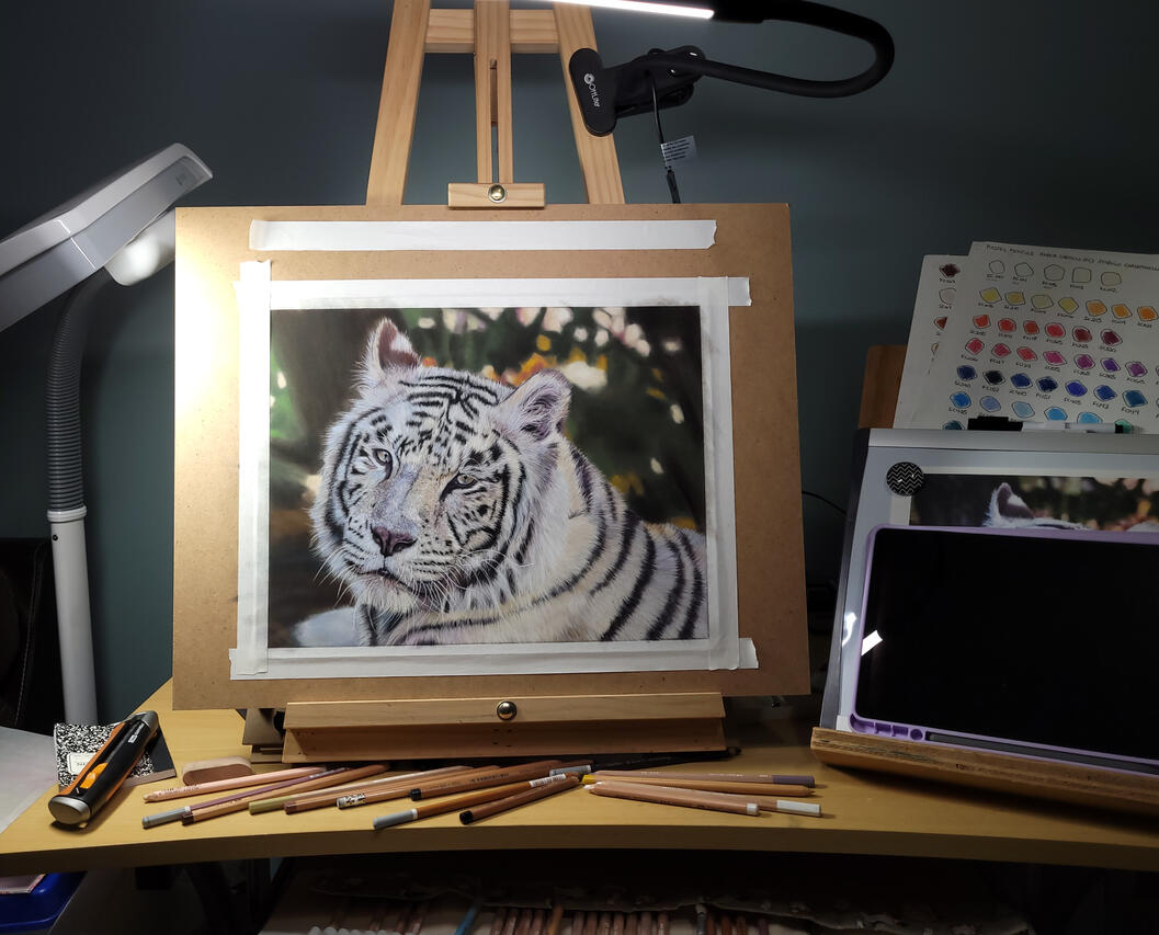 Tiger painting on easel.